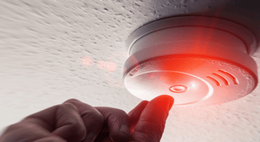 Home smoke detector being tested